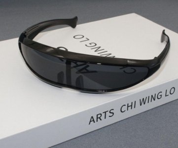 Black luxury sunglasses with curved modern frame, dark lenses, unisex style, lightweight build, ideal for fashion, travel and outdoor sun protection